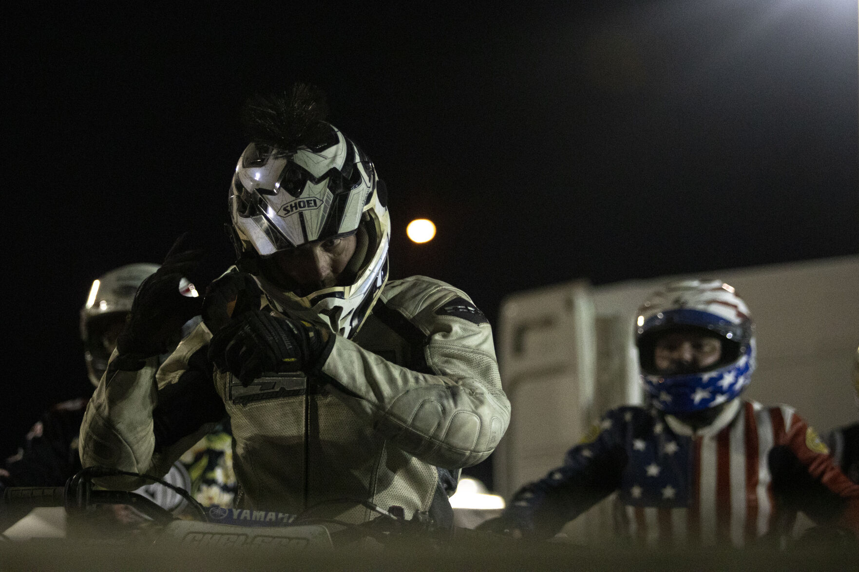 A Racer Puts on A Helmet